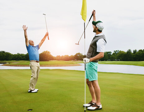 People, together or celebrate on golf course for winning put, success with sports challenge or competition. Outdoor, exercise or healthy men on green with flag, excited for performance with par score