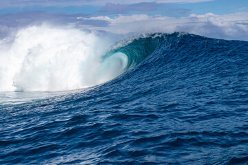 Fototapeta premium Monster waves at Teahupoo, Tahiti, French Polynesia - a world famous spot for surfing championships. The village of Teahupoo is known as “The end of the road” because the road from Papeete ends there.