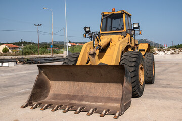 Bulldozer on construction site on sunny summer day. Heavy duty construction equipment. Closeup