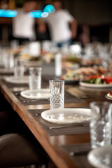 Set of empty glasses and plates on a restaurant table