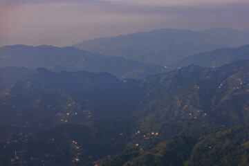 Landscape horizon line in the mountains, orange sunset and blue mountains.