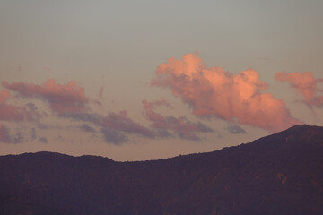 Landscape horizon line in the mountains, orange sunset and blue mountains.