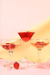 Modern still life with pink martini, alcoholic cocktail with champagne, strawberries on elegant modern background, minimal concept for bar and holiday party, cafe, advertising banner, selective focus,