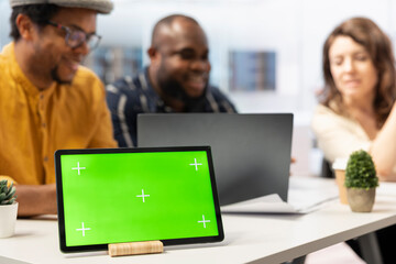 Real estate agent presenting urban building layout next to green screen, discussing about a high class office space leasing for business relocation. Clients looking to invest in property.