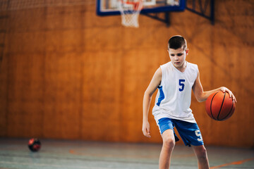 Naklejka premium Young player practicing ball dribbling skills