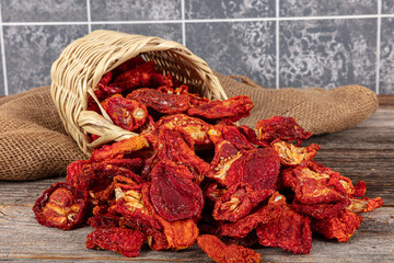 Sun dried tomatoes, dried red and yellow cherry tomatoes, close up, top view. Sun dried tomato background. Dried dehydrated tomato chips. Healthy eating concept.