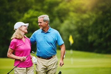 Senior, couple and walking on golf course, outside and healthy fitness activity with golfers together with club. Relaxing, weekend break and happy with smile for sport, nature exercise and people