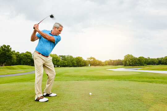Mature, man and swinging on golf course or nature for recreation sport, practice and training for tournament match. Male golfer, country club and playing with skill for coordination and exercise.