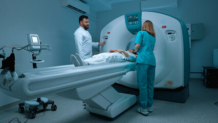 Doctor in conducting MRI tomography. Patient undergoing MRI examination. Modern equipped cabinet in...