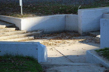 cement resting place on walking path with two staircases