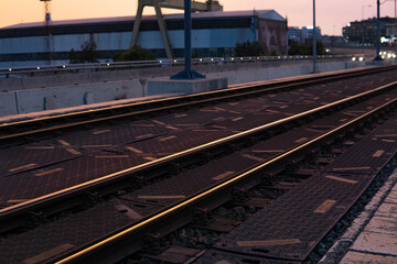 Fototapeta premium close-up of railway tracks in the setting sun. High quality photo
