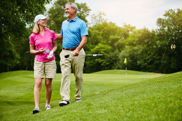 Mature, couple and walk for golf in nature, outside and healthy fitness activity with golfers...
