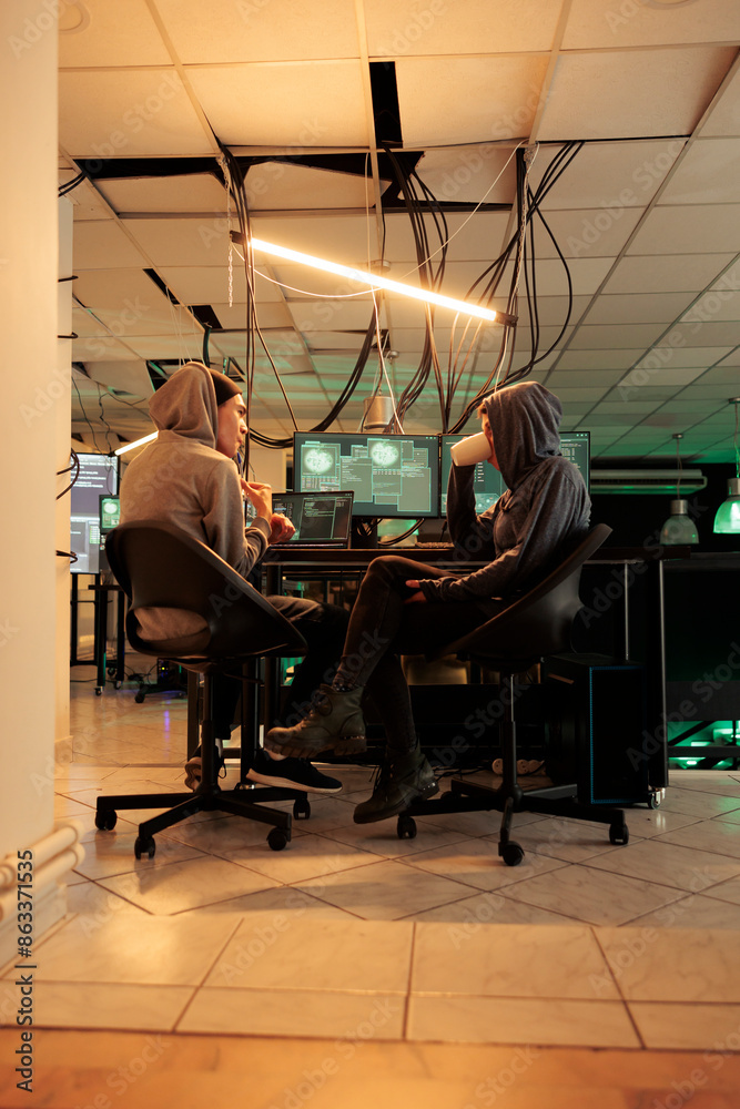 Poster young hackers coding trojan virus program to hack system, it specialists programming illegal firewal