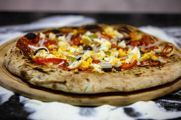 traditional Portuguese pizza with boiled eggs, black olives, ham