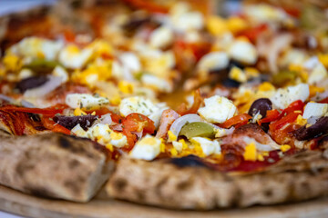 traditional Portuguese pizza with boiled eggs, black olives, ham