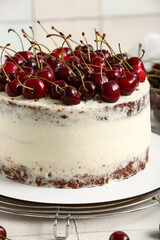 Grid with tasty cherry cake on white tile background