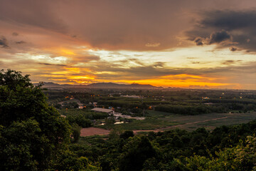 Background of trees growing along the sea coast, rain clouds covering and wind blowing blurred during the rainy season at the Noen Nang Phaya viewpoint, Chanthaburi, Thailand.