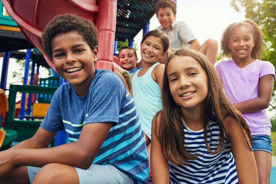 Portrait, friends and kids with smile, playground and happiness with weekend break, outdoor and bonding together. Face, group and children with fun, recreation and sunshine with leisure and diversity