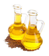 Decanters with flax oil and seeds on white background