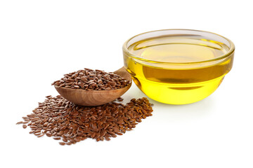 Glass bowl of flax oil and wooden spoon with seeds on white background
