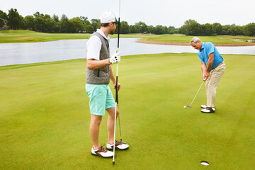 Men, golf course and game for tee off in morning as members in club for health, wellness or...