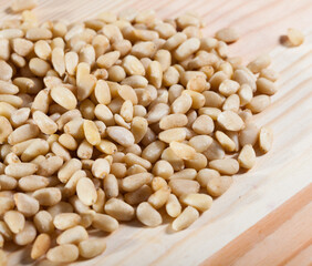 Pine nuts on a wooden surface. Natural background