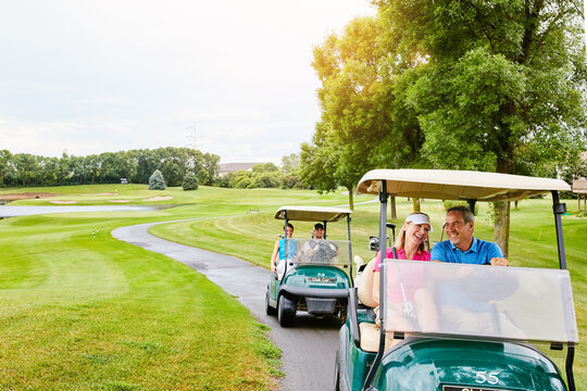 People, golf cart and outside course in nature, happy and relax in transport path or country club hobby on weekend break. Fitness, driving and smile for sport game conversation, golfers and together