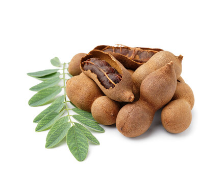 Heap of tasty tamarinds and leaf on white background