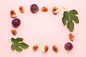 Frame made of fresh ripe figs and leaves on pink background