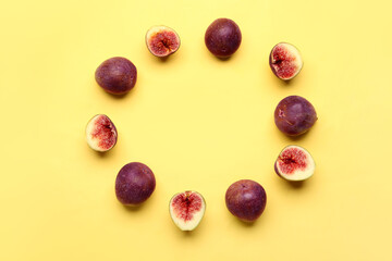 Frame made of fresh ripe figs on yellow background