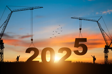 Silhouette of construction camp site with cranes building construction prepare to welcome the new year 2025 at sunset.