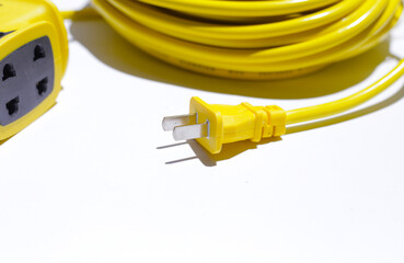 Yellow extension electric cable reel on white background.