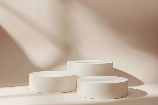 Minimalist product display with three white round podiums on beige background with sunlight.