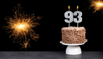 Birthday celebration with cake and candle number 93