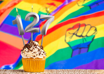 Birthday candle number 127 - Gay march flag background