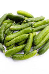 Mini cucumbers on white background.