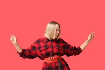 Beautiful young woman with bob hairstyle on red background