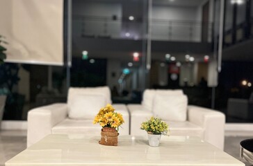 Bouquet of yellow flowers in vase on the table.
