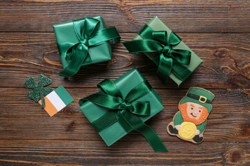 Gift boxes with gingerbread cookie and decor for St. Patrick's Day celebration on wooden background