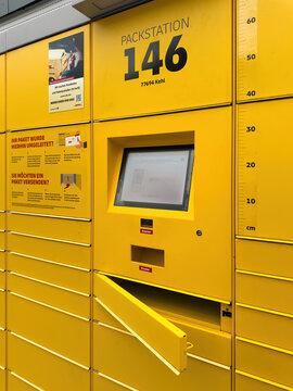 Kehl, Germany - Apr 2024: A yellow DHL Packstation 146 in Kehl, Germany, featuring an interactive screen, parcel compartments, designed for automated package retrieval shipping