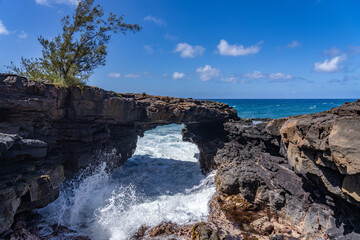 Fototapeta premium Lava rock Sea Arch, Makahuena Light, Koloa, Kauai South Shore，Hawaii. Koloa Volcanics 