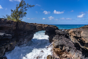 Fototapeta premium Lava rock Sea Arch, Makahuena Light, Koloa, Kauai South Shore，Hawaii. Koloa Volcanics 