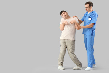 Fototapeta premium Medical professional assisting patient with movement disorder, rehabilitation and healthcare support, the doctor supports the patient's arm and shoulder