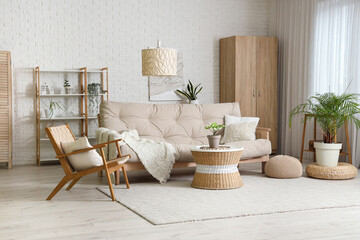 Stylish interior of living room with cozy sofa, armchair and coffee table