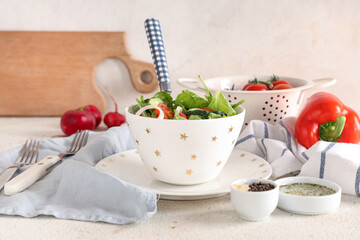 Bowl of fresh vegetable salad with tomato and cucumber on white background