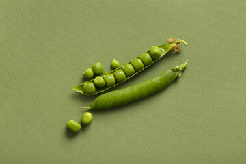 Fresh peas on green background