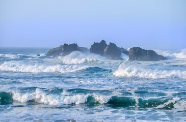 Big waves with white foam and seastaks. Sea shore. Oregon. USA