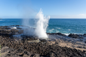 A blowhole on Kauai's south shore near Poipu, Hawaii, USA. 
The blowhole shoots seawater through its natural lava tube up to 50 feet in the air.
