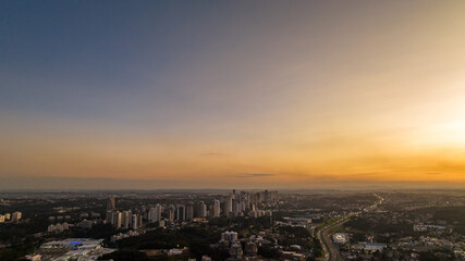 Curitiba in Paraná, Brazil. Aerial View. Wonderful sunset with views of buildings and Tanguá Park. Lake with reflection..