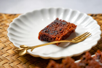 Kek Buah Kukus, a traditional Malaysian steamed fruit cake filled with dried fruits, nuts, and spices, enjoyed during celebrations.